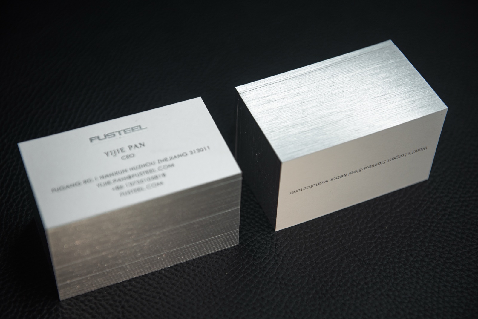 Two pale card stacks showing bright reflective silver-coloured edges.