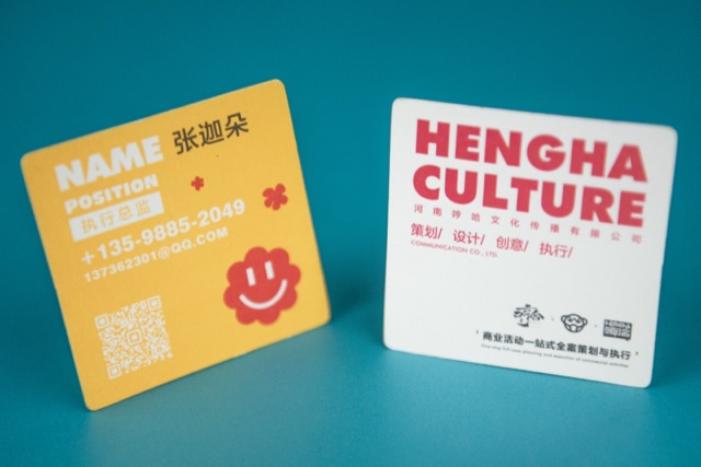 A yellow and white card pairing with oversized red and pale lettering.