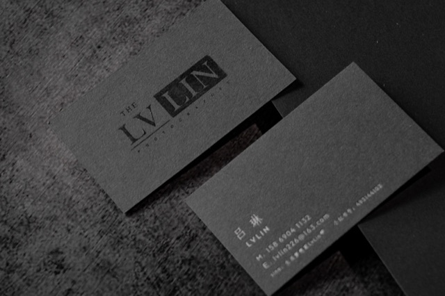 A charcoal card pair with dark glossy lettering against a matte-looking surface.