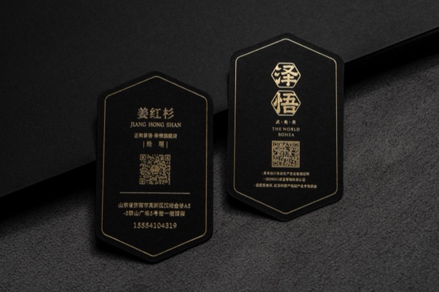 Dark cards with clipped corners, a thin border and gold-coloured text.
