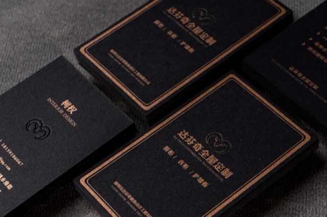 Several black cards with fine copper-coloured border lines and centred text.