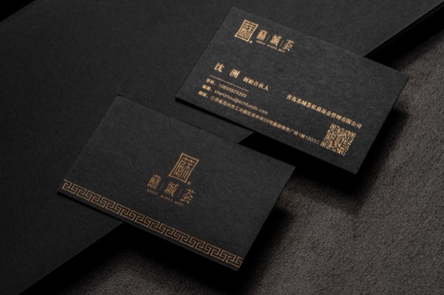 Dark cards with metallic-looking gold type and a small grid-like geometric motif.