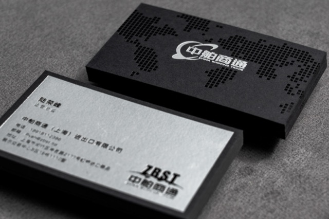 A dark and light card pair using a dotted map-like pattern and pale lettering.