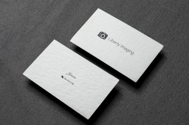 A pair of pale cards with a small dark icon and delicate black type.