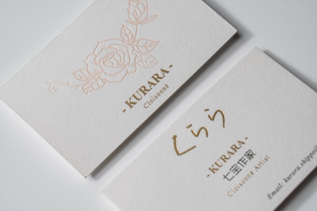 White cards with reflective floral linework and matching fine lettering.