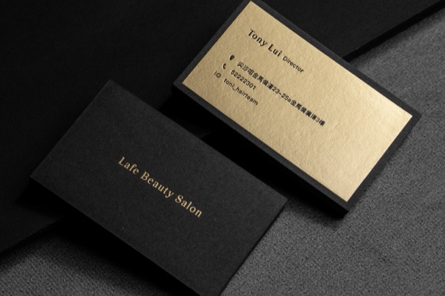 A black card pair with one broad reflective gold-coloured panel.