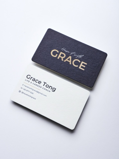 A black and white rounded card pair with a reflective gold name on the dark face.