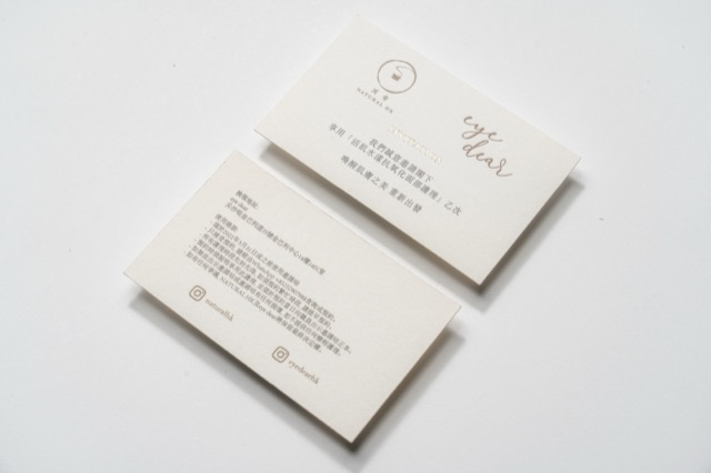 Soft ivory cards with fine script-like lettering and compact contact details.