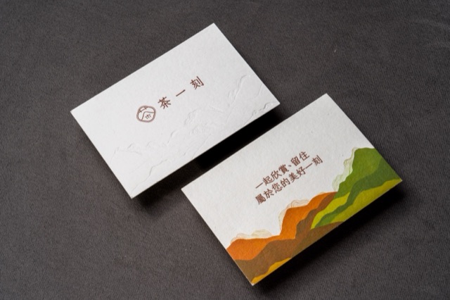White cards with a layered landscape illustration in warm and green colours.