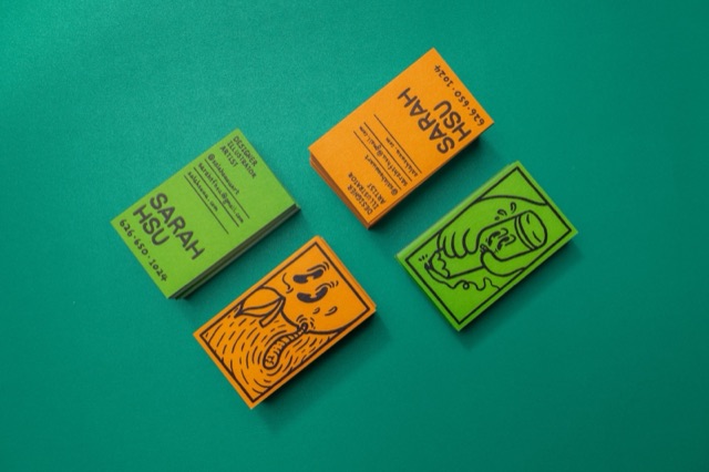 Lime and orange cards with bold black illustrated faces arranged on a teal background.