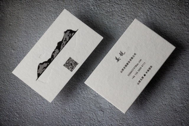 Textured pale cards with a black mountain illustration and vertical typography.