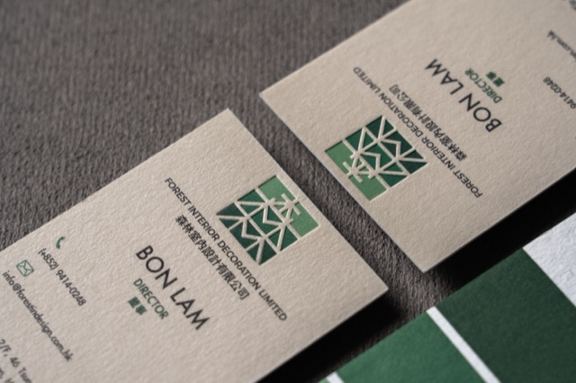 Natural-coloured cards with green geometric artwork photographed with a green companion card.