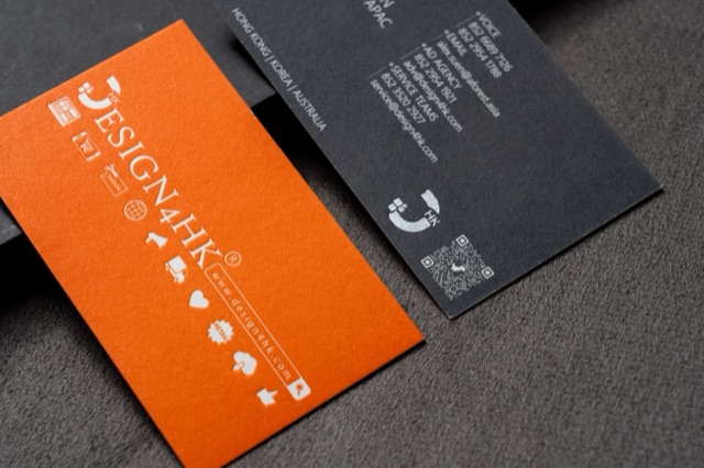An orange and charcoal card pairing with pale lettering on both faces.