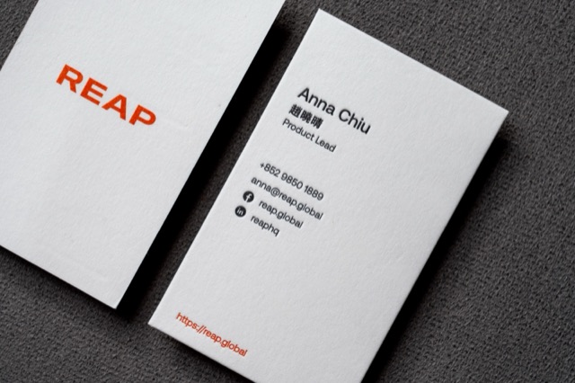 Minimal white cards with a small orange wordmark and black contact typography.