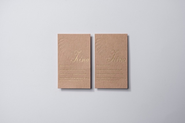 Peach-coloured cards with a visible irregular surface and fine pale lettering.