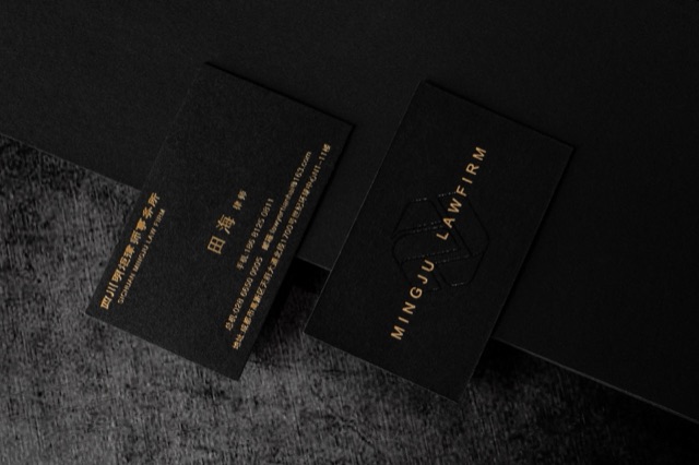 Two black cards with a narrow arrangement of fine gold-coloured lettering.