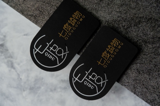 Black cards with strongly rounded upper corners and gold-coloured text.