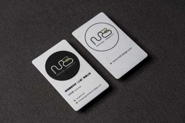 Two small rounded white cards featuring a simple outlined monogram.
