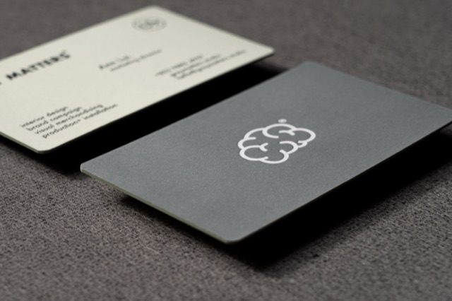 Grey and ivory cards with softly rounded corners and restrained linework.