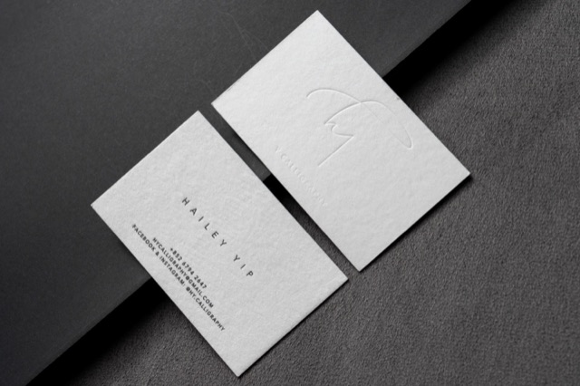 A pale card pair with a large subtle curved line mark visible across one face.
