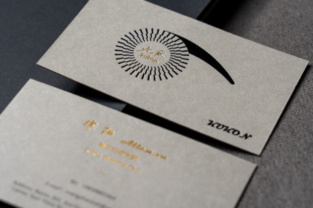 Pale cards with a bold black radial illustration and a few gold-coloured details.
