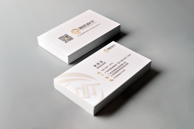 White card stacks with a gold geometric mark and delicate gold details.