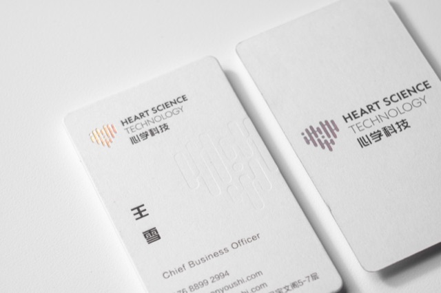 A close view of white cards with rounded corners and a small multicoloured line symbol.