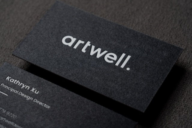 A dark textured card pair with bold white lettering on the front.