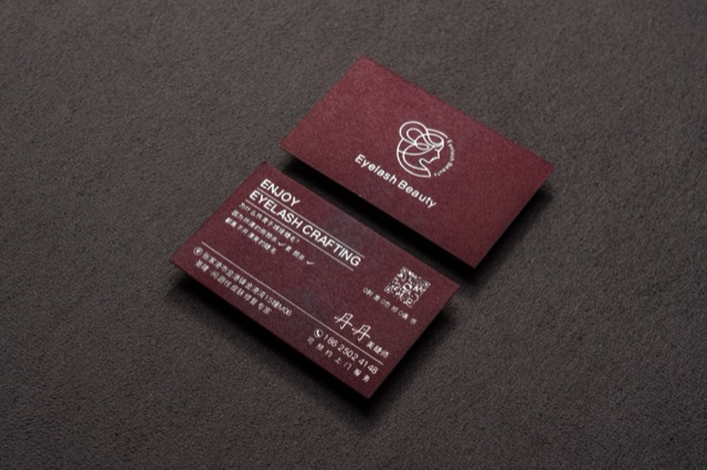 Wine-red cards with a delicate pale line illustration and compact lettering.
