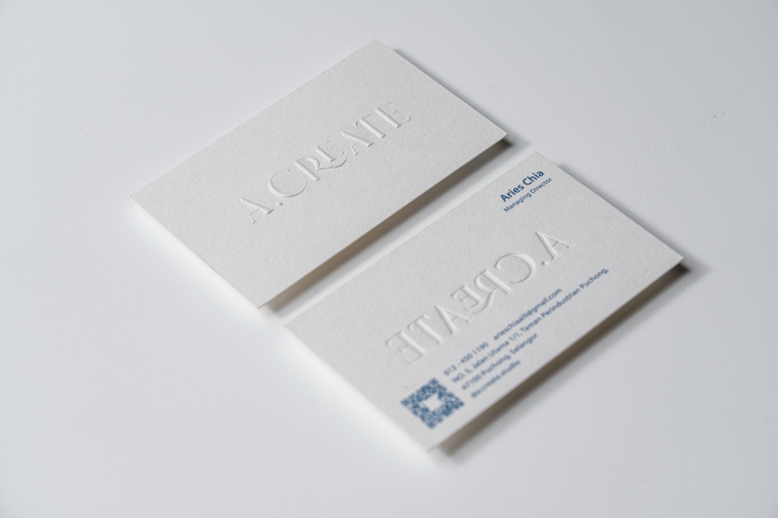 A light card pair using large white-on-white lettering and small dark details.