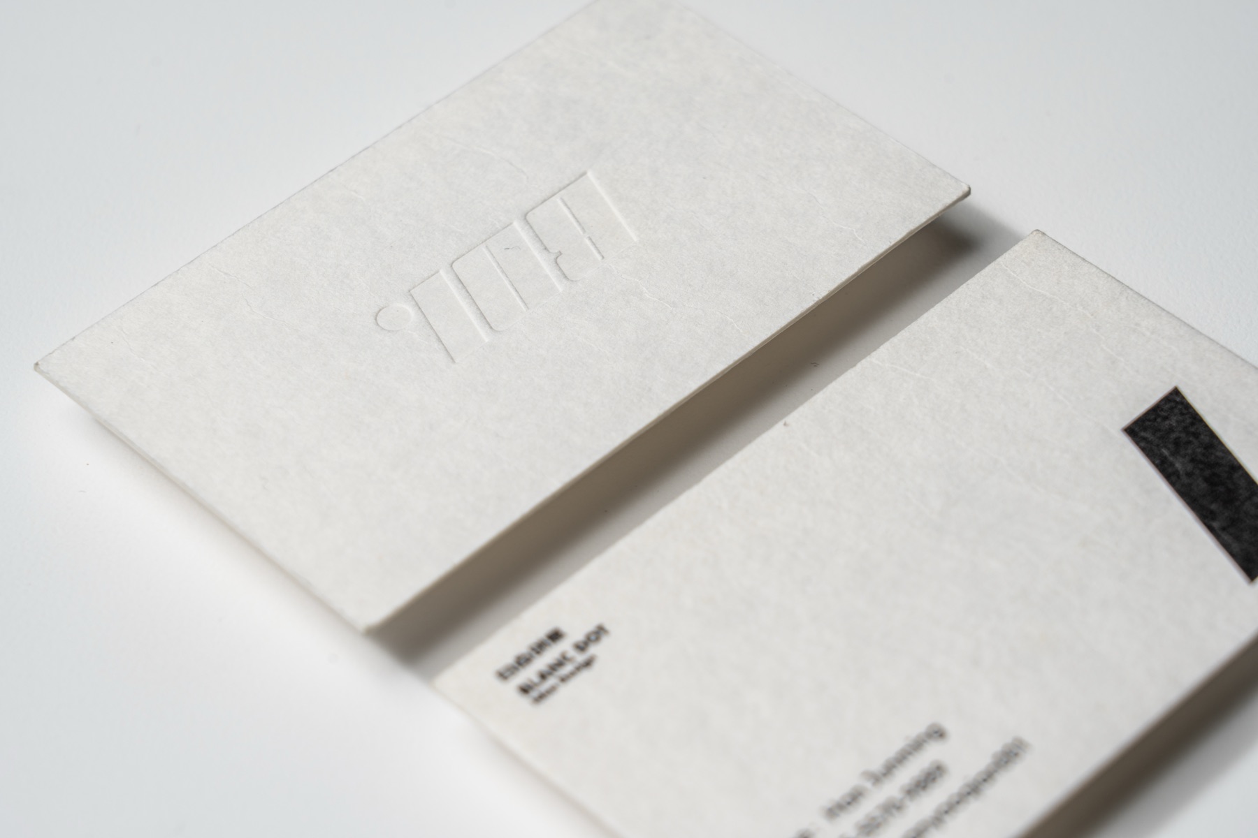 Textured white paper with an uninked impression