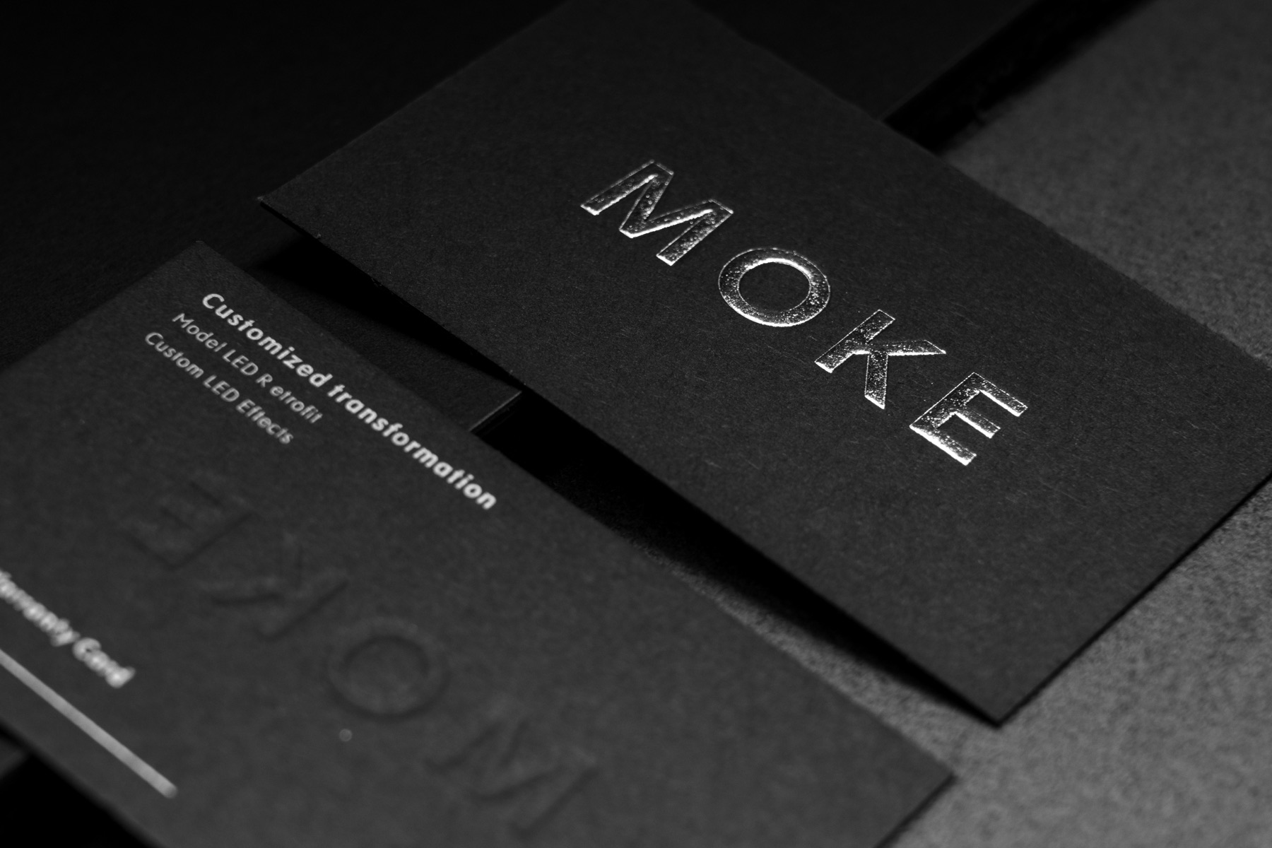 Black textured cards with metallic lettering